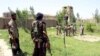 Afghan militias and policemen gather during a battle in Kunduz on May 3.