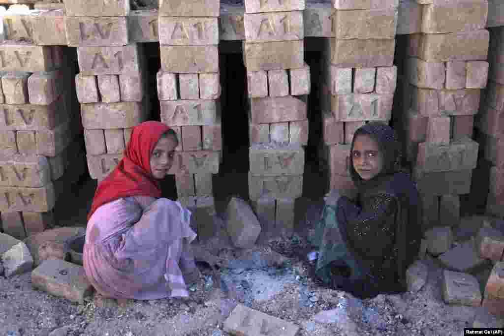 Children sift through coal ash used at a brick factory on the outskirts of Kabul. Thousands of children work to make money to support their families in Afghanistan. (AP/Rahmat Gul)