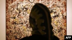 A woman admires "Mural on Indian Red Ground" when it was on exhibit at Tehran's Museum of Contemporary Art in 2005.