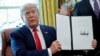 U.S. -- U.S. President Donald Trump displays an executive order imposing fresh sanctions on Iran in the Oval Office of the White House in Washington, June 24, 2019