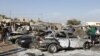 Residents gather at the site of a car-bomb attack in the Shuala district in Baghdad on January 22.