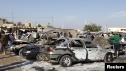 Residents gather at the site of a car-bomb attack in the Shuala district in Baghdad on January 22.