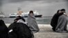 Children wrapped in blankets stand in a harbor as migrants and refugees arrive on the Greek island of Lesbos while crossing the Aegean Sea from Turkey earlier this month. Hundreds if thousands of migrants have made a similar journey from Turkey, which is struggling to host 2.7 million registered refugees from Syria, plus an unknown number of unregistered refugees. (file photo)