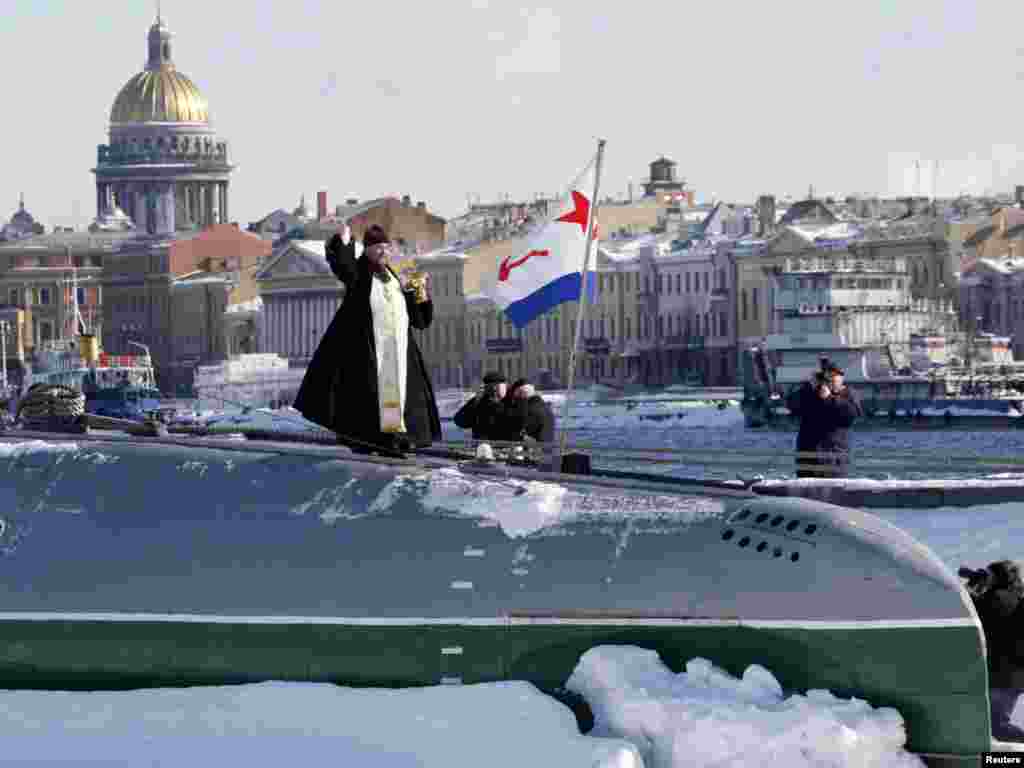 A priest sanctifies the first Russian private submarine museum during its opening ceremony in St. Petersburg. - Photo by Alexander Demianchuk for Reuters
