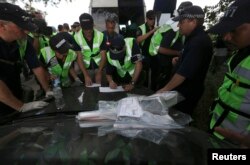 Dutch and Australian forensic experts working at the site of the downed Malaysian airliner near the village of Rozsypne in the Donetsk region on August 4