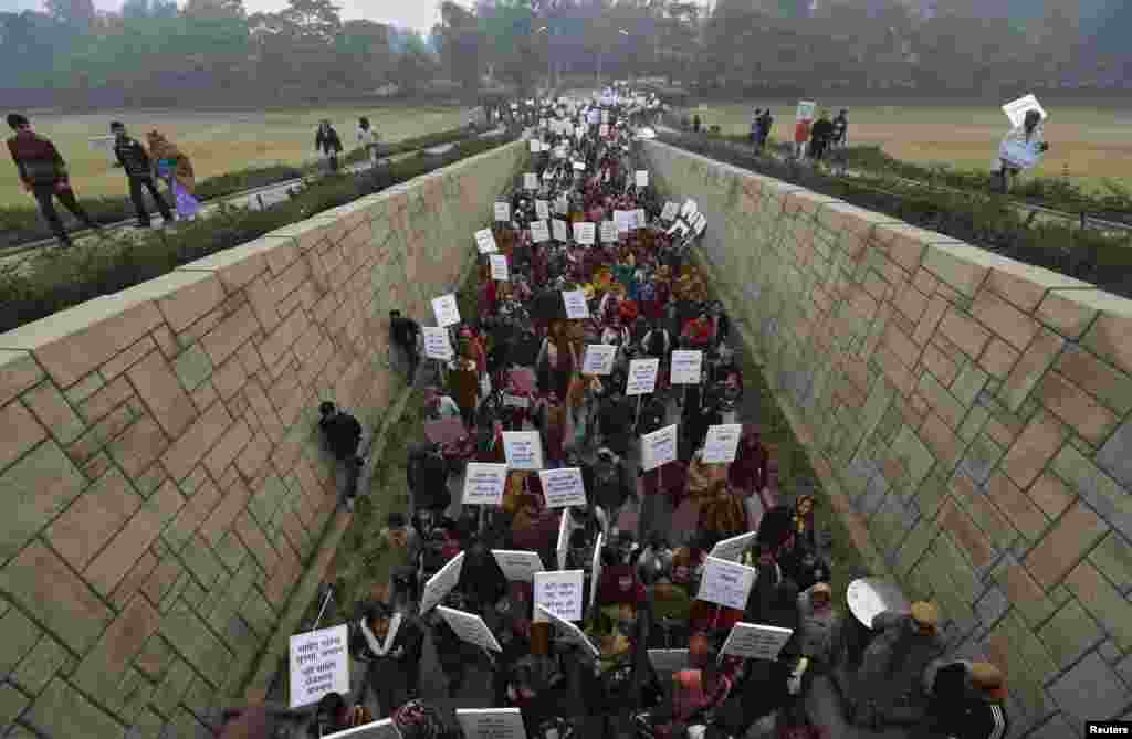 Women carrying placards attend a prayer ceremony in New Delhi for the victim of a gang rape. The ashes of the Indian student who died were scattered in the Ganges River as reports of more attacks stoked a growing national debate on violence against women. (Reuters/Adnan Abidi)