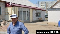 Омирхан Жетесов перед домом, к которому он периодически возводит пристройки. Актобе, 30 июля 2016