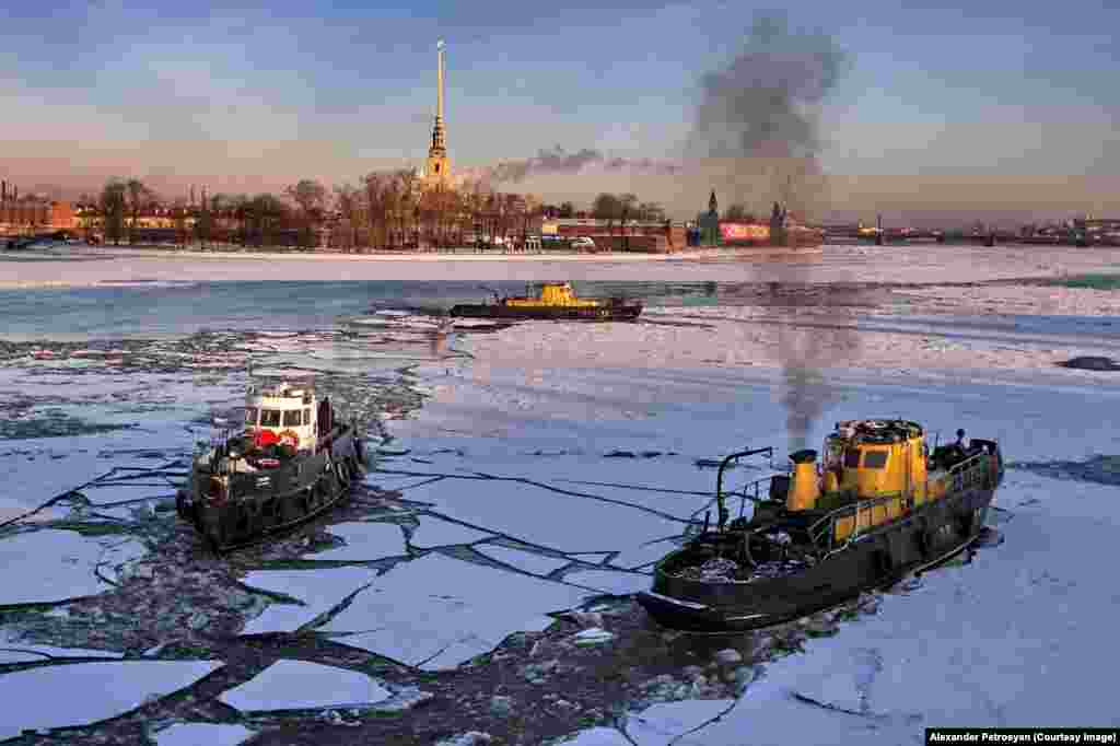 Boats cracking through ice on the River Neva.