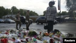 A woman looks at floral tributes placed near the scene of the killing of British soldier Lee Rigby in Woolwich, London, on May 23.