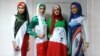 Iranian models presenting outfits bearing the national flag's colors, the logo of the national football team and the design of the 2014 World Cup during a fashion show organized by the House of Fashion and the "Violet Models" agency in Tehran.