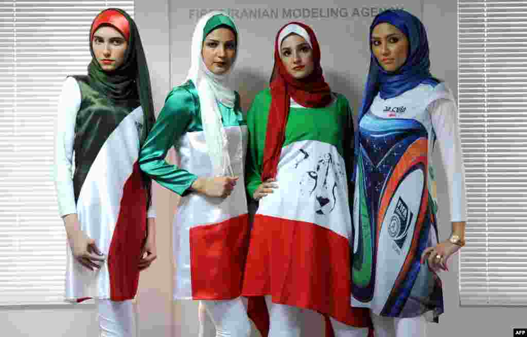 Iranian models present outfits bearing the national flag&#39;s colors, the logo of the national soccer team, and the design of the WC2014 Brazuca balls during a fashion show organized by the House of Fashion and the &quot;Violet Models&quot; agency inTehran. (AFP/Bahareh Asadi)