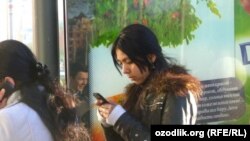 Uzbekistan - Uzbek girl is using a mobile phone, undated