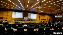 International Atomic Energy Agency (IAEA) Director General Rafael Grossi waits for the start of an interactive board of governors meeting in an nearly empty meeting room at the IAEA headquarters amid the coronavirus pandemic. June 15, 2020