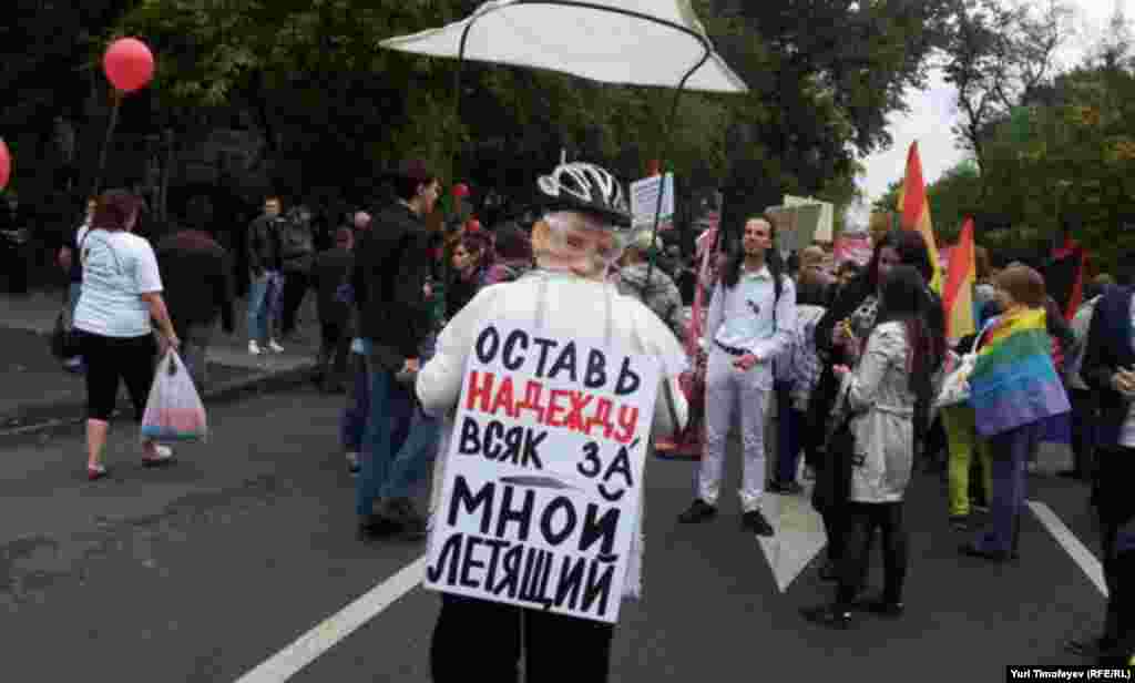In a reference to Putin's recent escapade flying an ultralight aircraft to try and teach young cranes how to migrate, this woman's sign reads: "Abandon hope anyone flying behind me."