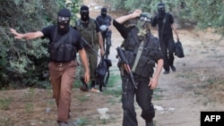 Palestinian Popular Resistance Committees (PRC) fighters return from positions on the border between the Gaza Strip and Israel in 2008.