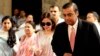 India's corporate giant Reliance Industries Ltd. Chairman Mukesh Ambani, right, accompanied by his wife Nita, second from left, arrives for the company's annual general meeting in Mumbai, India, Friday, June 3, 2011. 