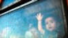 A migrant boy looks through a window onboard a train for Serbia at the new transit center for migrants at the border line between Greece and Macedonia near the town of Gevgelija, Macedonia. (AFP/Robert Atanasovski)