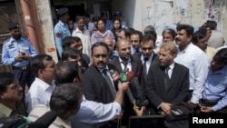 Tahir Naveed Chaudhry (left), a lawyer for Rimsha Masih, a Christian girl accused of blasphemy, speaks to the media along with other lawyers after he appeared before a judge at the district court in Islamabad on September 3.