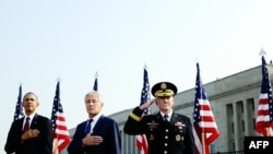 U.S. President Barack Obama (left to right), Defense Secretary Chuck Hagel, and Joint Chiefs Chairman General Martin Dempsey pay their respects at the Pentagon Memorial to mark the 12th anniversary of the 9/11 attacks.