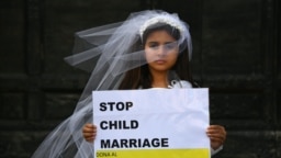 A young actress plays the role of Giorgia, 10, forced to marry Paolo, 47, during a happening organized by Amnesty International to denounce child marriage, on October 27, 2016 in Rome.