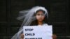 ITALY -- A young actress plays the role of Giorgia, 10, forced to marry Paolo, 47, during a happening organised by Amnesty International to denounce child marriage, on October 27, 2016 in Rome.