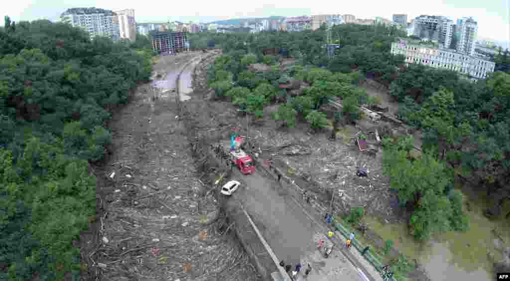 Debris covers a road where the Vere river burst its banks.