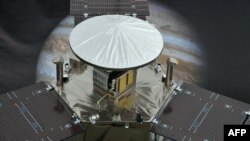 A model of NASA's Juno Spacecraft in front of an image of Jupiter at the Jet Propulsion Laboratory in California.