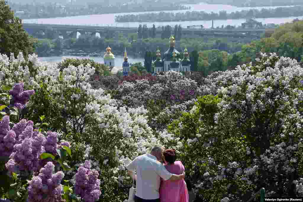 A couple shares a kiss among the lilacs in a park in Kyiv. (Reuters/Valentyn Ogirenko)