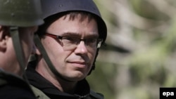 Estonian Defense Minister Sven Mikser observes a military drill in May.