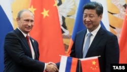 Chinese President Xi Jinping attends a signing ceremony with Russian President Vladimir Putin (left) at the Great Hall of the People in Beijing in September 2015.