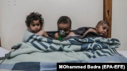 Syrian children receive treatment for a suspected chemical attack at a makeshift clinic in the eastern Ghouta region on the outskirts of Damascus on February 25.
