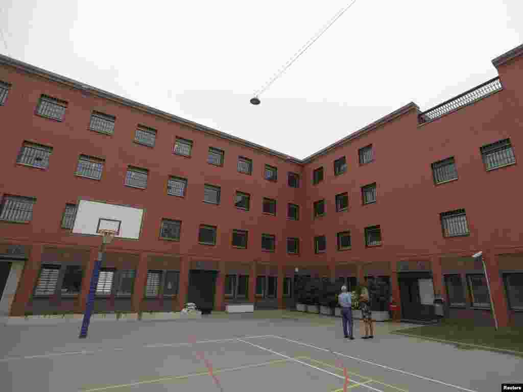 Tennis and basketball courts are seen in the yard of the Detention Unit.