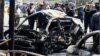 The wreckage of a car is seen at the site of bombing near a government office in Baghdad's Karkh district on May 30.