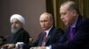 Russian President Vladimir Putin (C), Turkish President Recep Tayyip Erdogan (R) and Iranian President Hassan Rouhani address the media after a trilateral meeting on Syria in Sochi on November 22, 2017