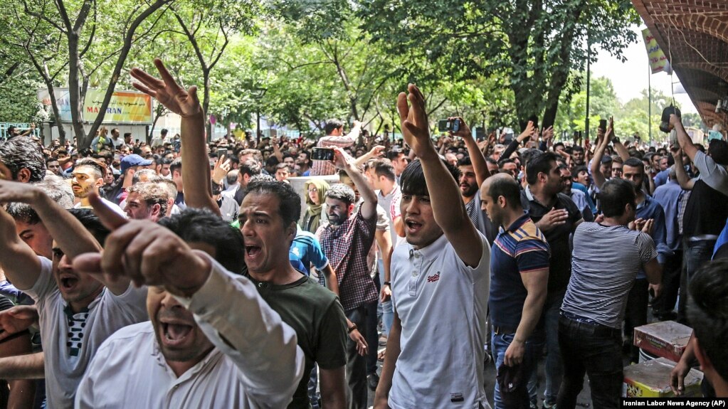 Iran -- A group of protesters chant slogans at the old grand bazaar in Tehran, Iran, Monday, June 25, 2018.