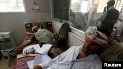 Wounded men receive treatment, after the blast in Jalalabad.