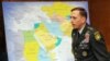 Petraeus walks by a map of what will be his area of responsibility.