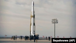 An Iranian rocket carrying a satellite is prepared for launch from an undisclosed site believed to be in the Semnan province, April 22, 2020