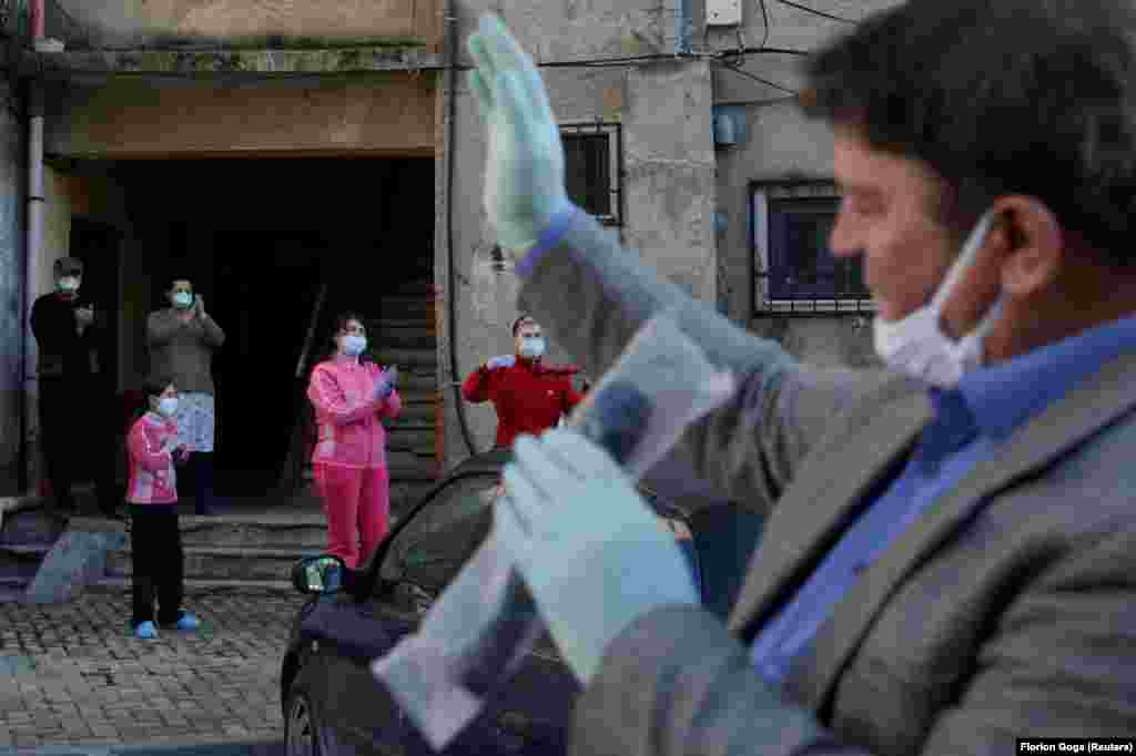 A singer entertains an apartment block during lockdown in Durres, Albania, on April 7.