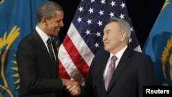 U.S. President Barack Obama greets his Kazakh counterpart Nursultan Nazarbaev at a meeting in Seoul