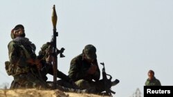 Rebel fighters try to spot coalition planes along Benghazi-Ajdabiya road.