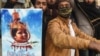 FILE: Pakistani Islamists hold a poster displaying the portrait of Asia Bibi, a Christian Pakistani woman accused of blasphemy, during a protest against the Supreme Court decision on Bibi's case in Lahore in February.