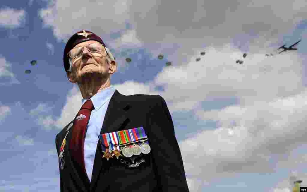 Fred Glover, formerly of the British 9th Parachute Regiment, watches a parachute drop at Ranville in Normandy, France, on June 5, during 70th anniversary commemorations of the D-Day landings on June 6, 1944. (Andy Rain, epa)