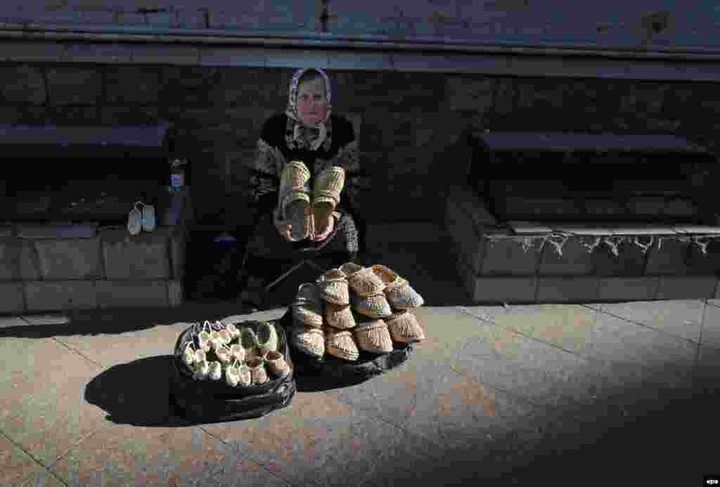 &nbsp;A woman sells handmade shoes in central Moscow, Russia. (epa/Yuri Kochetkov)