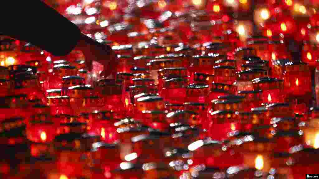 NOVEMBER 1, 2012 -- A man lights candles during All Saint&#39;s Day at a cemetery in Zagreb, Croatia. (Reuters/Antonio Bronic)