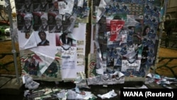 Parliamentary election campaign posters are seen at the end of the parliamentary election in Tehran, February 20, 2020