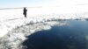 A photo released by Russia's Emergency Situations Ministry on February 15 shows a hole in surface ice on a lake in the Chelyabinsk region thought to have been caused by a meteorite strike earlier the same day.