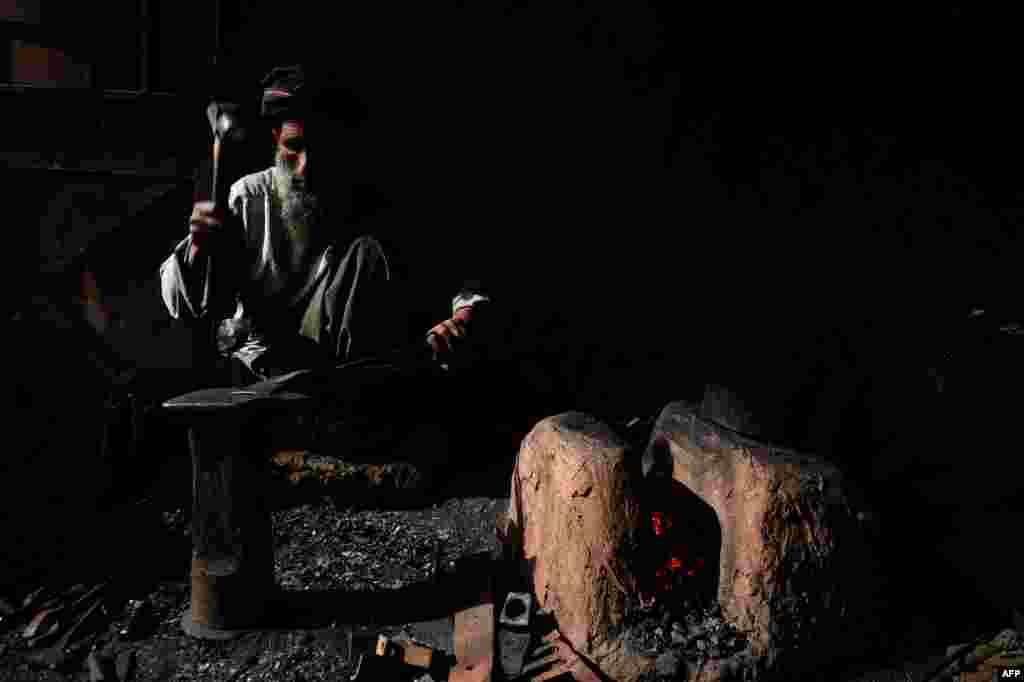 An Afghan man works in a ironsmith at a local factory in Herat. (AFP/Aref Karimi)