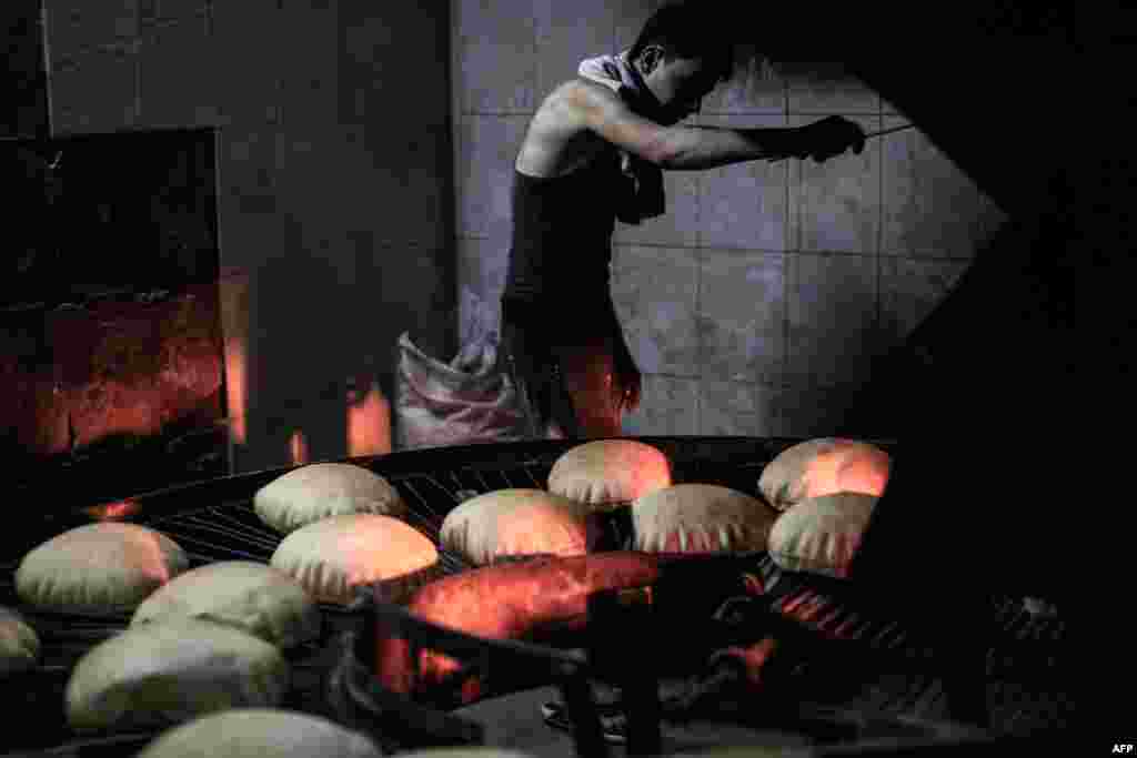 A Syrian man works at a bakery in the rebel-held town of Douma, east of the capital Damascus. (AFP/Sameer Al-Doumy)