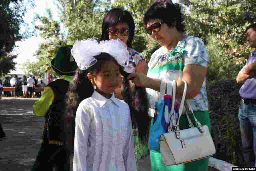 Putting the finishing touches on a back-to-school outfit at School No. 82 at the Ala-Too settlement outside of Bishkek.